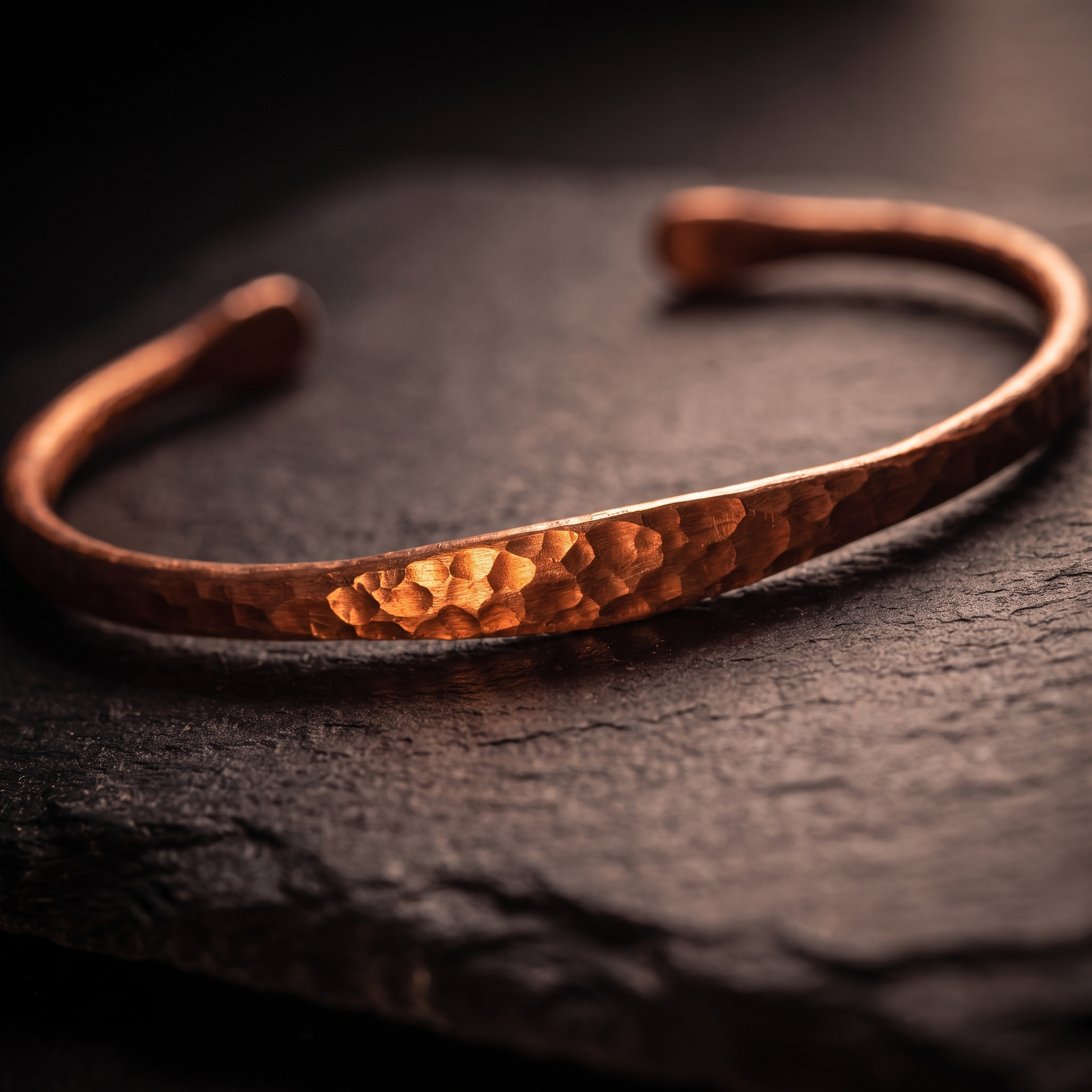 Macro close-up of the hand-hammered texture on the copper bangle
