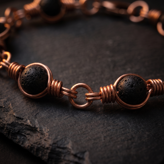 Macro close-up of lava stone beads in hand-coiled copper wire frames