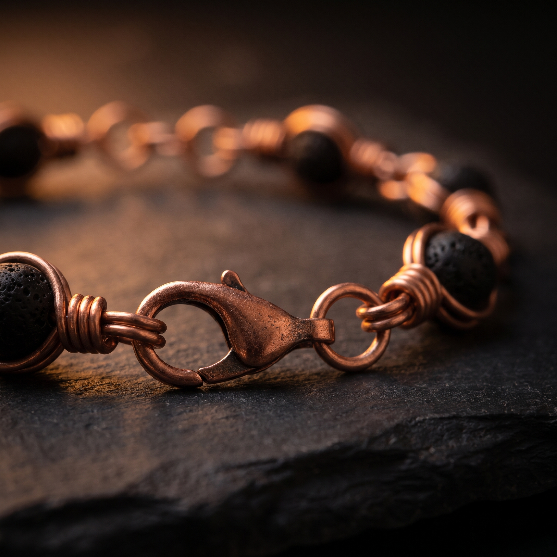 Macro close-up of the copper lobster clasp on the lava stone bracelet